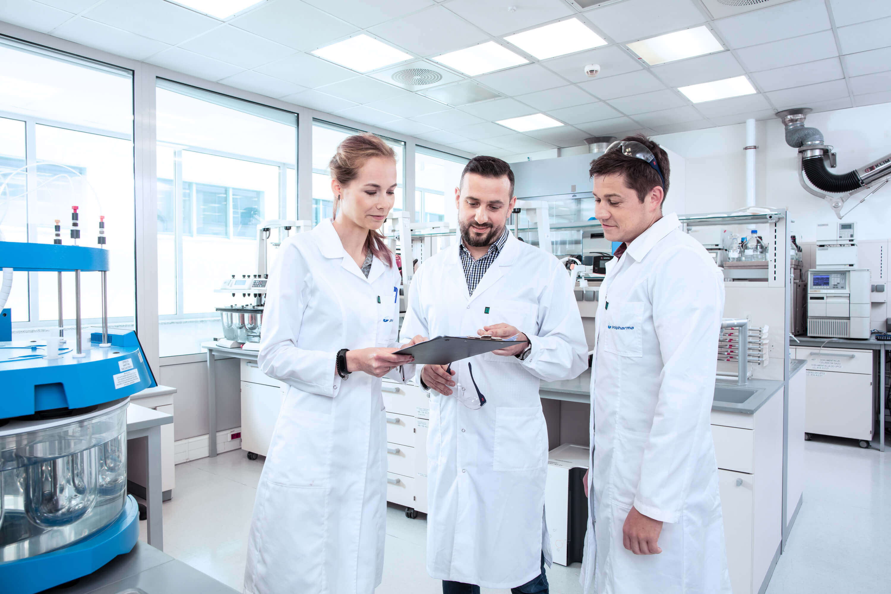 Three employees looking at a document