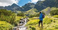 Sporty hiker near summer spring in Tatra Mountains national park, Zakopane, Poland